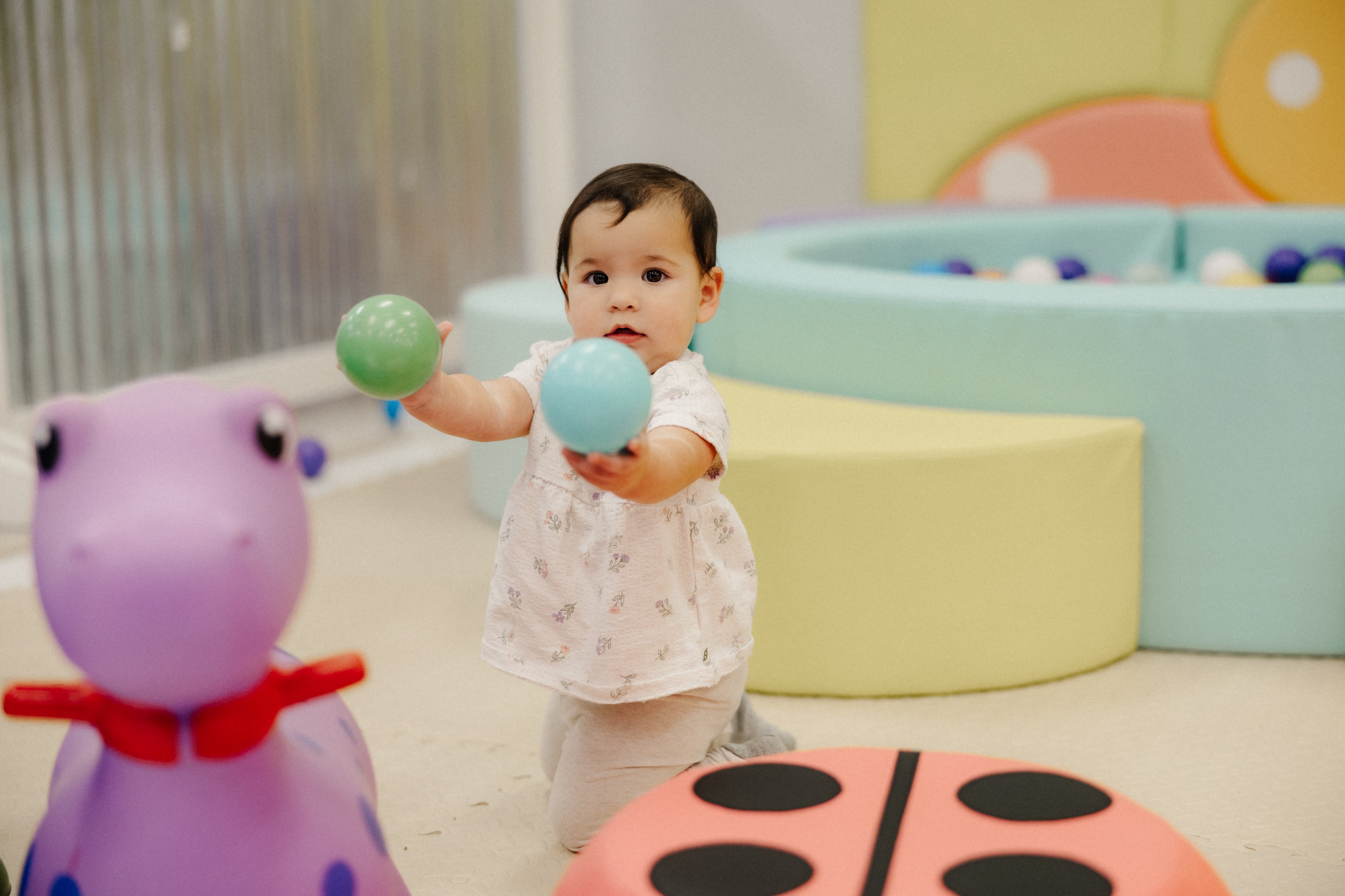 Toddler playing with colorful balls