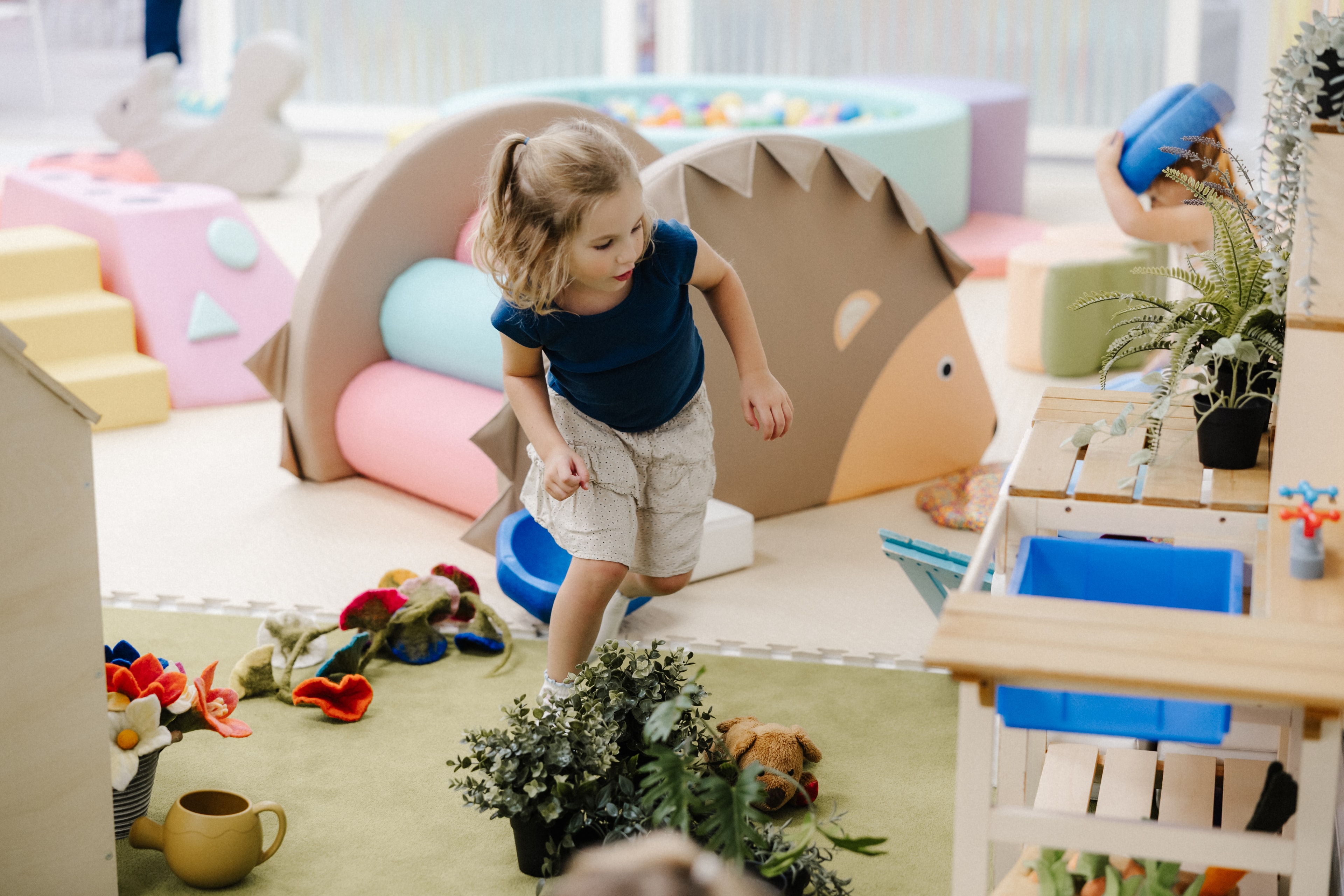 Toddler playing in colorful playroom