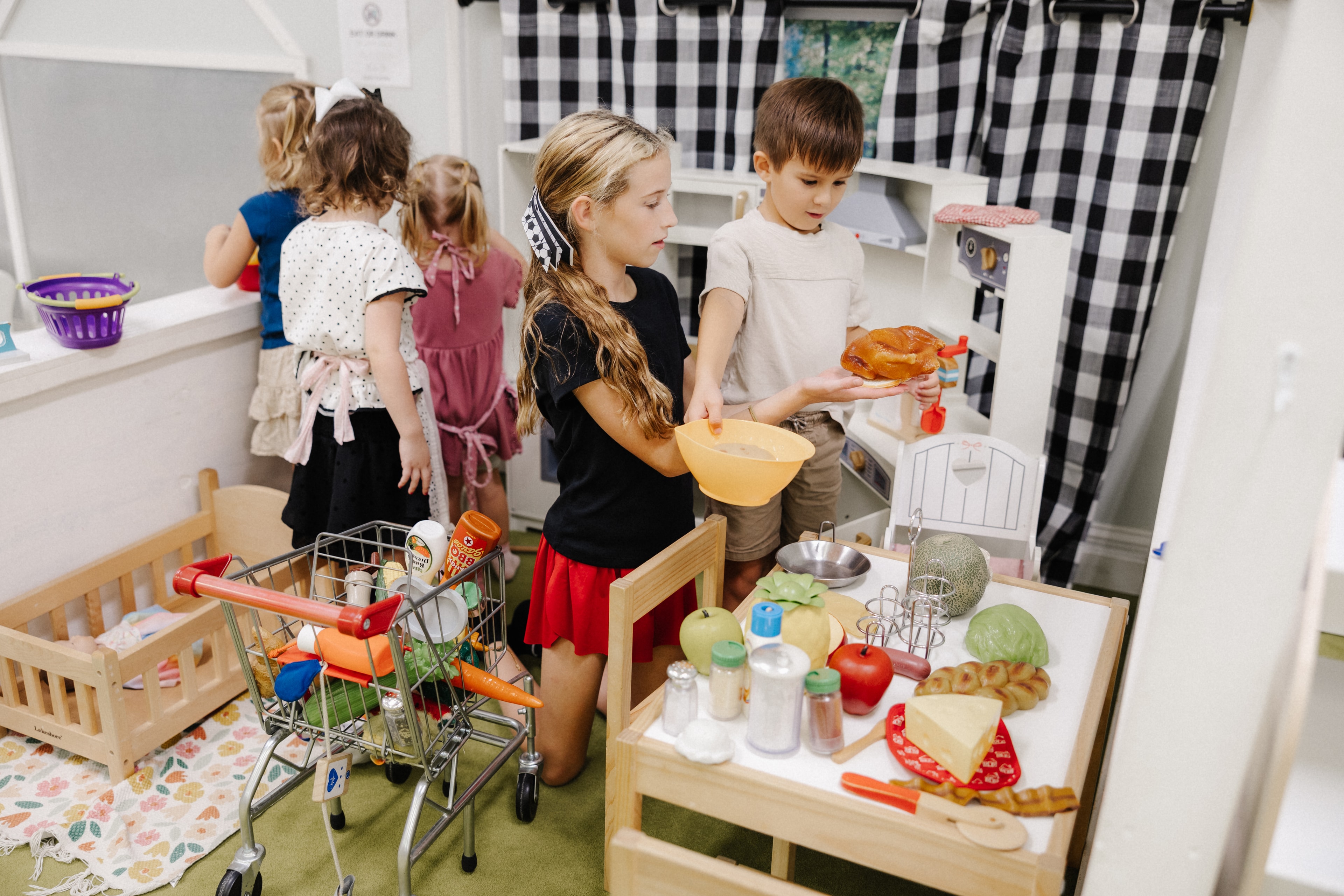 Children playing with toy kitchen